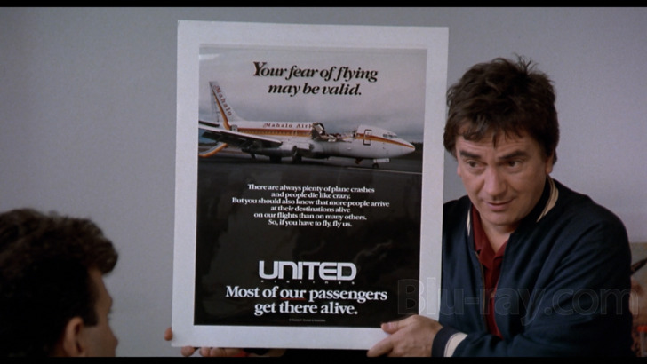 Dudley Moore hold up a United Airlines ad